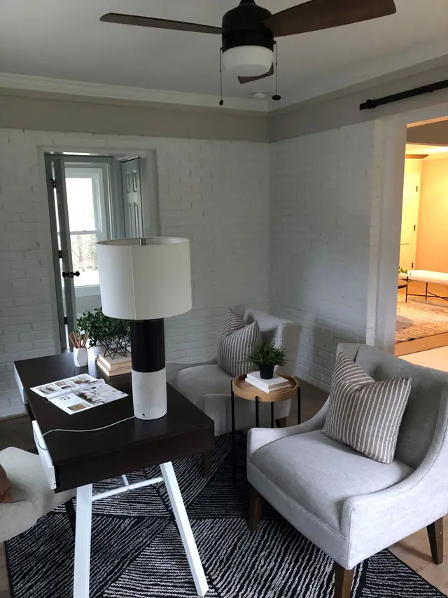 Sitting nook against a painted white brick wall