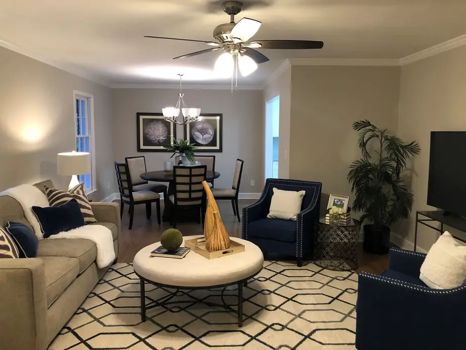 Living and dining room with a ceiling fan and a long dining table