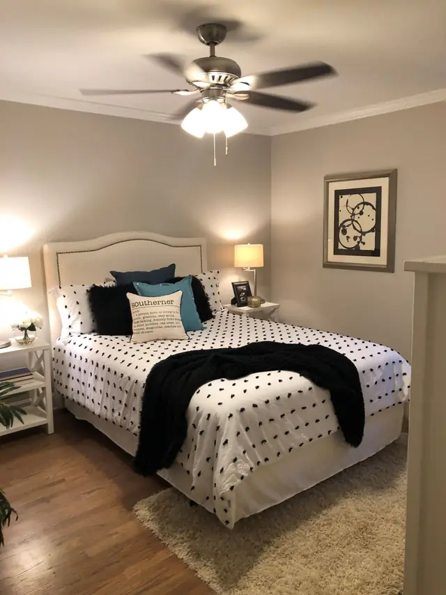 Bedroom with a white bed and a polka-dot duvet