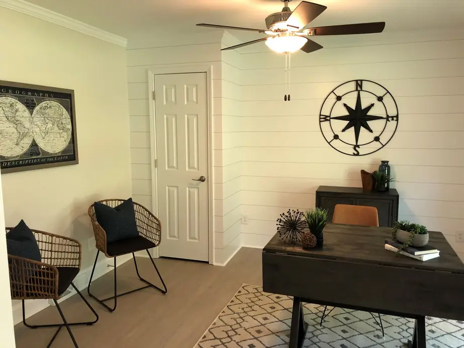 Office nook with a shiplap wall and compass art
